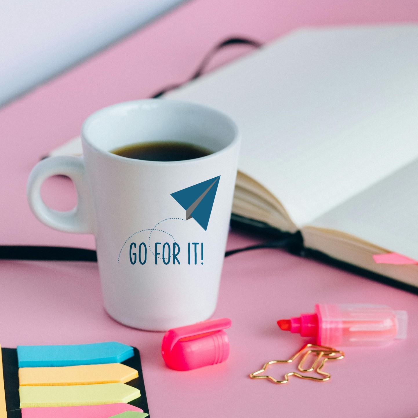 Coffee mug with "Go For It!" and image of a paper airplane 