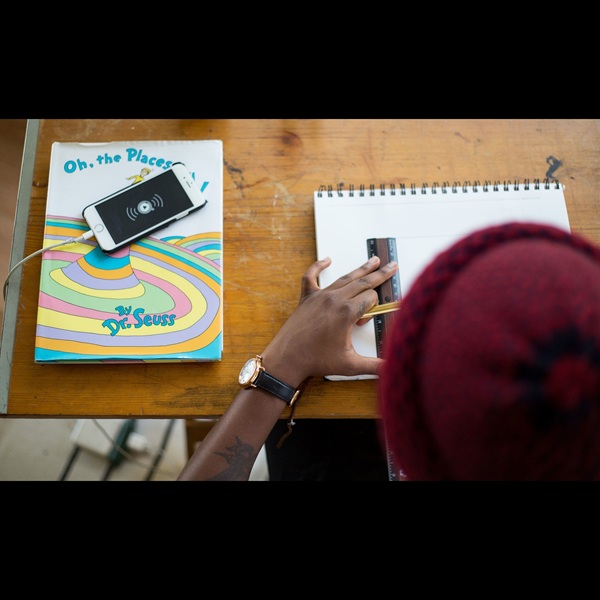man at a drafting table using a ruler