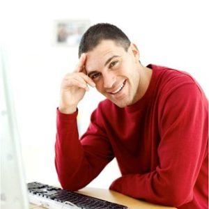 man at computer smiling